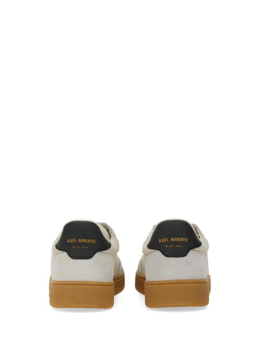 White sneakers with black accents and tan soles on a white background