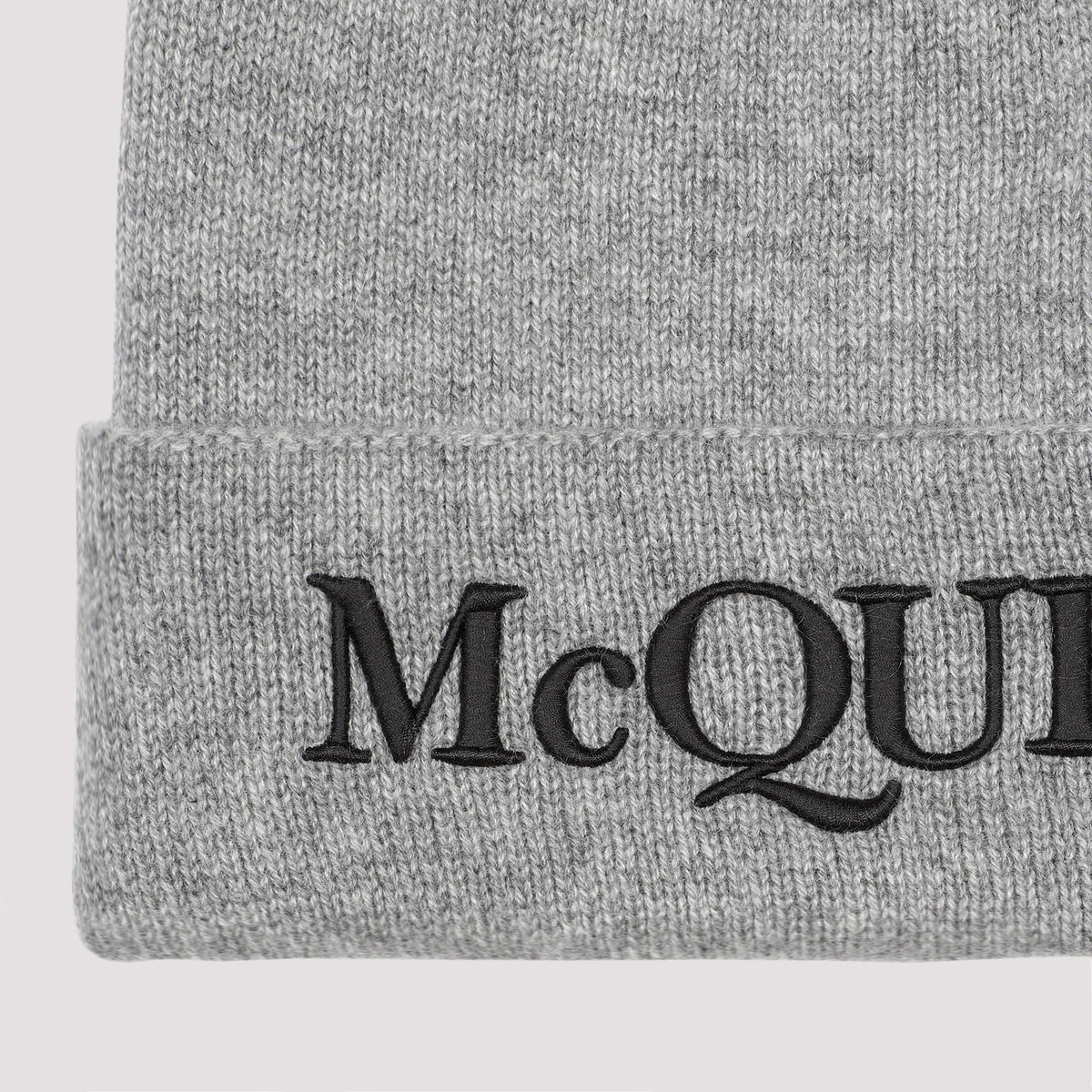 Gray knit beanie with 'McQ' logo on a white background