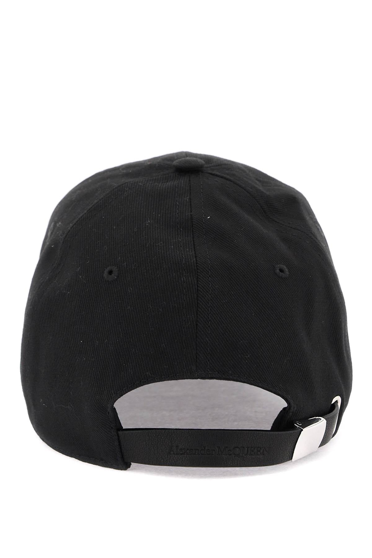 Rear view of a black baseball cap with an adjustable black strap and a silver metal buckle, on a white background.