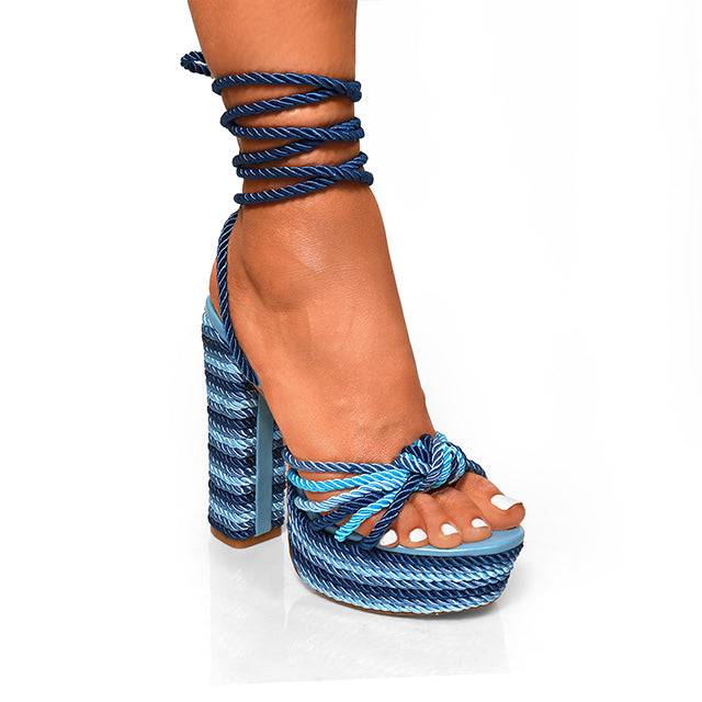 Blue rope-heeled sandals on a white background