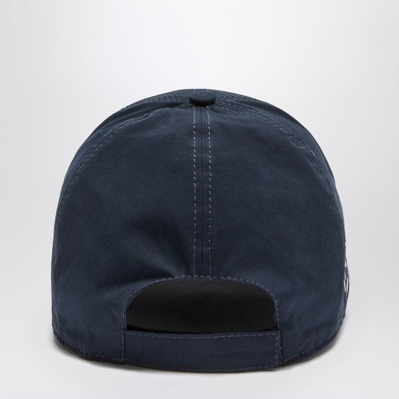 Navy blue baseball cap on a light gray background