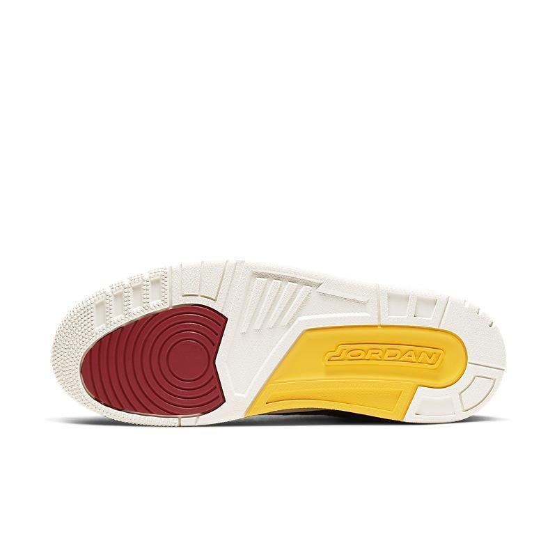 Close-up of a Jordan Air Jordan 3 Retro 'Animal Instinct 2.0' sneaker sole with red, yellow, and white colors on a white background