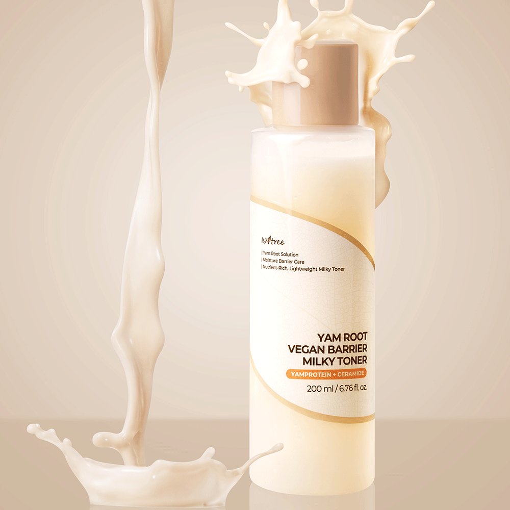 A bottle of Noveo Yam Root Vegan Barrier Milky Toner with a beige cap, set against a warm beige background with stylized milk splashes.