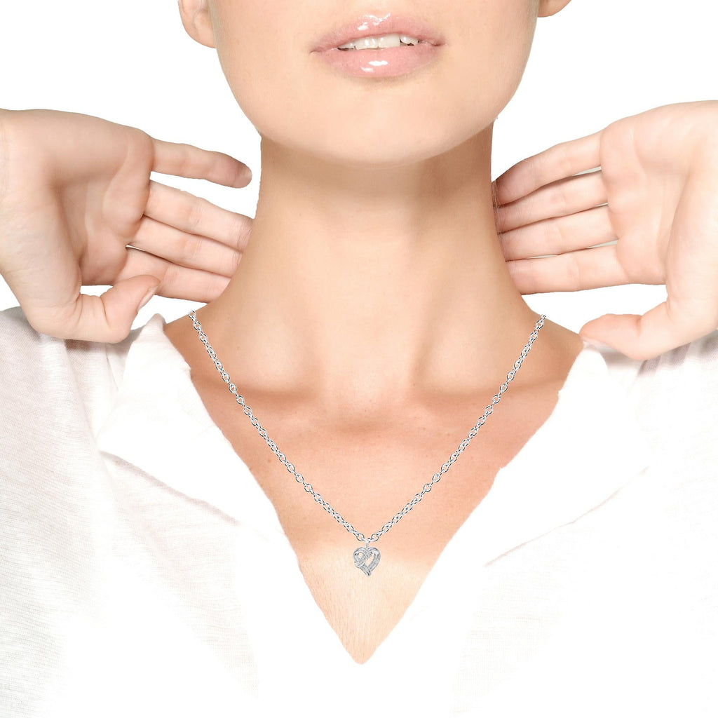 Person wearing a silver necklace with a rectangular pendant on a white background Luxury Fine Jewelry • Natural Diamonds • Sterling Silver • Romantic Gift Collection