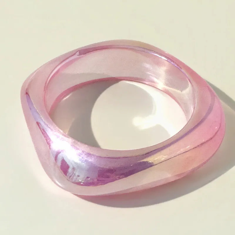 Pink and clear bangle on a light beige background