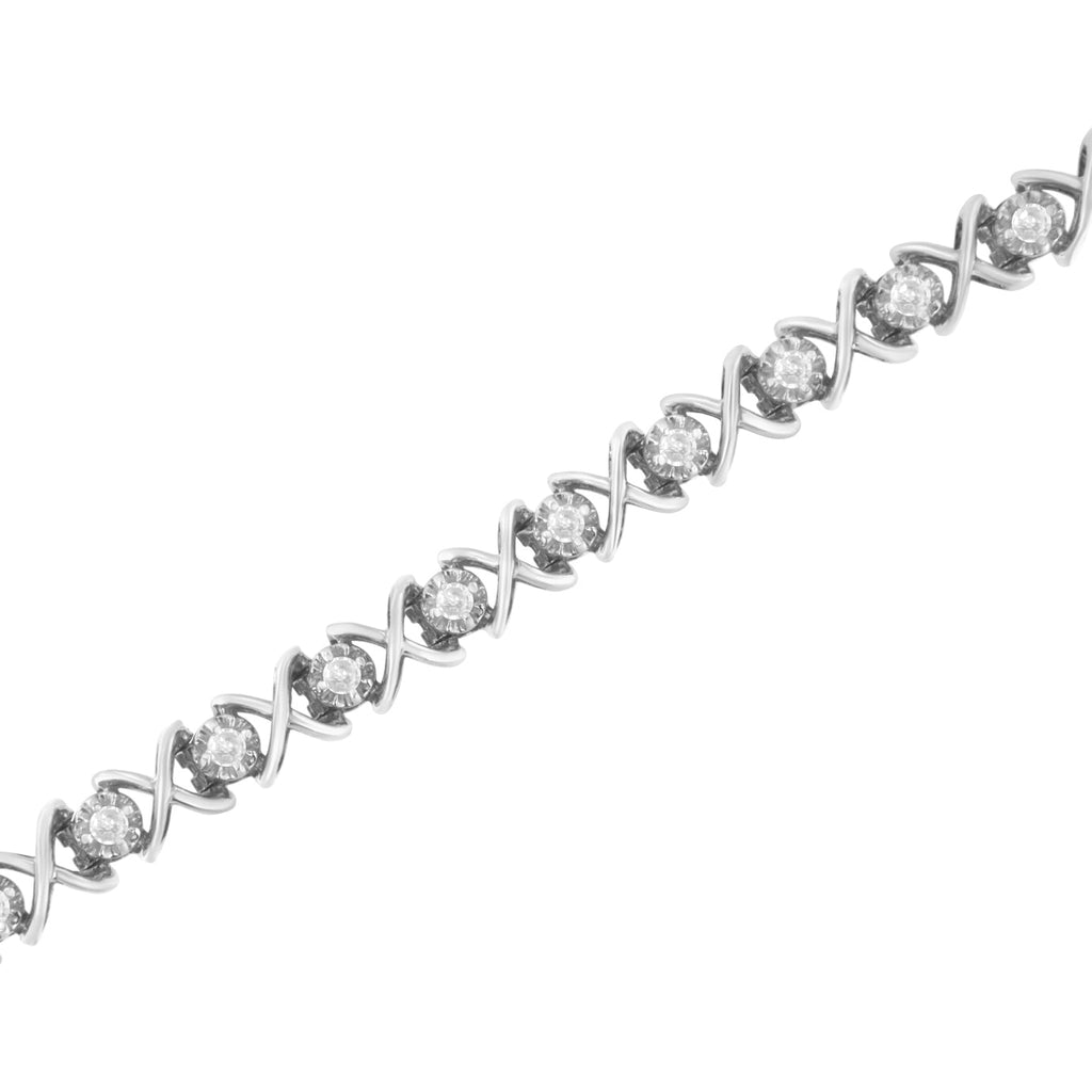 Silver bracelet with diamond accents on a white background