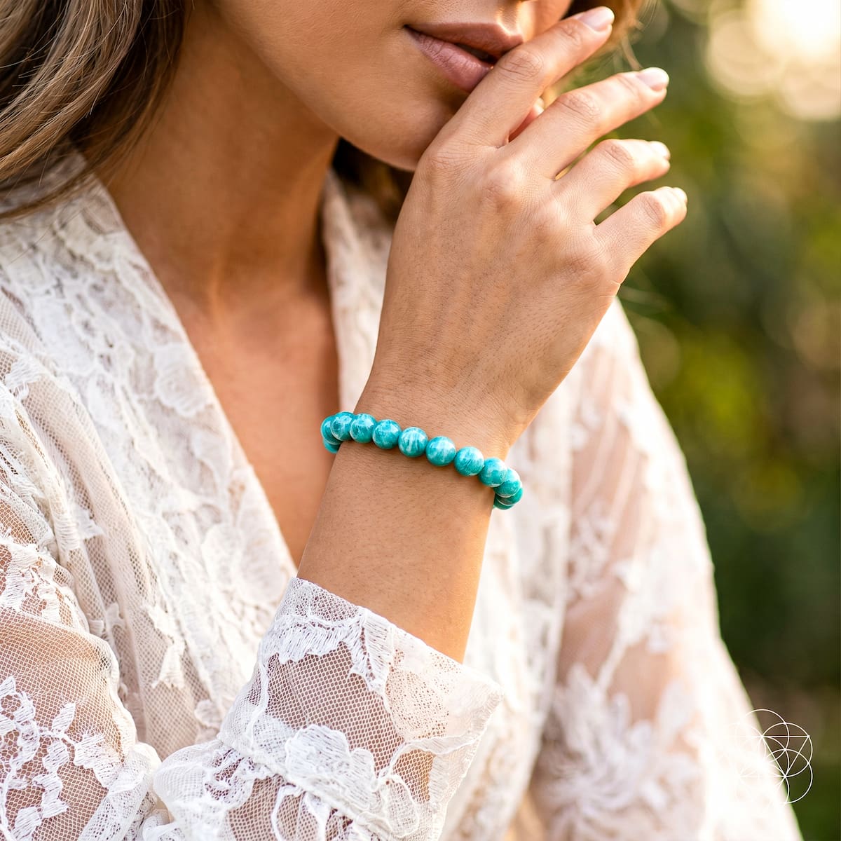 Close-up of a person wearing a turquoise bracelet with a blurred natural background Empire of Her Own – Premium Blue Amazonite Bracelet