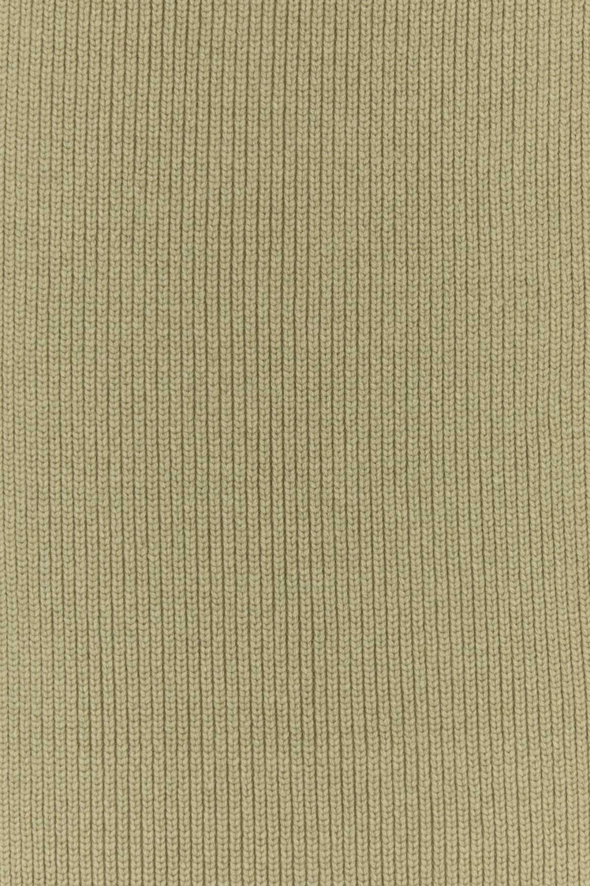 Close-up of a ribbed knit fabric in a muted olive-beige color, showing the vertical texture pattern.