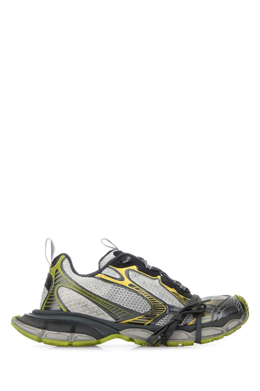 Gray and green athletic shoe on a white background