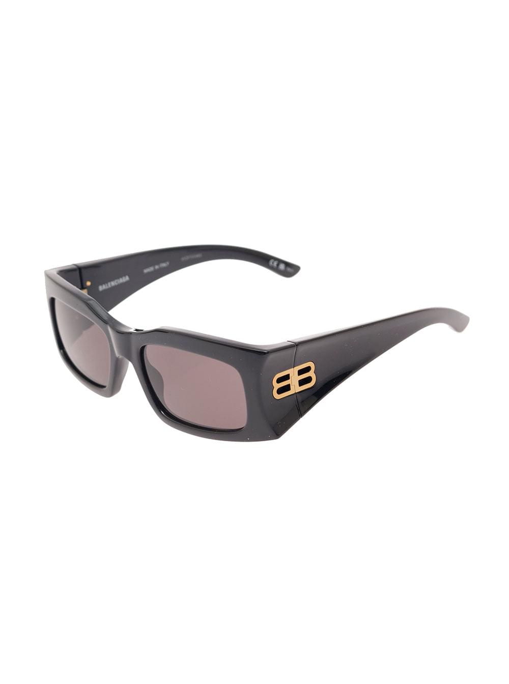 Balenciaga black rectangular sunglasses featuring dark tinted lenses and gold-tone BB logo hardware on the temples, displayed on a clean white background.