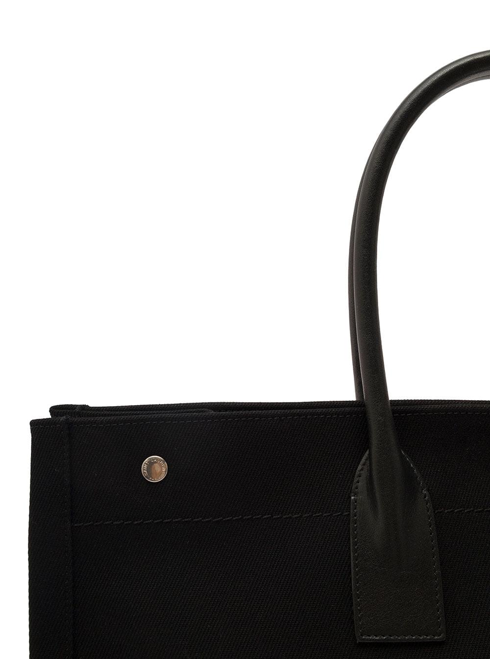 Saint Laurent Rive Gauche black cotton tote bag featuring leather top handles and white logo print, shown against a clean white background.