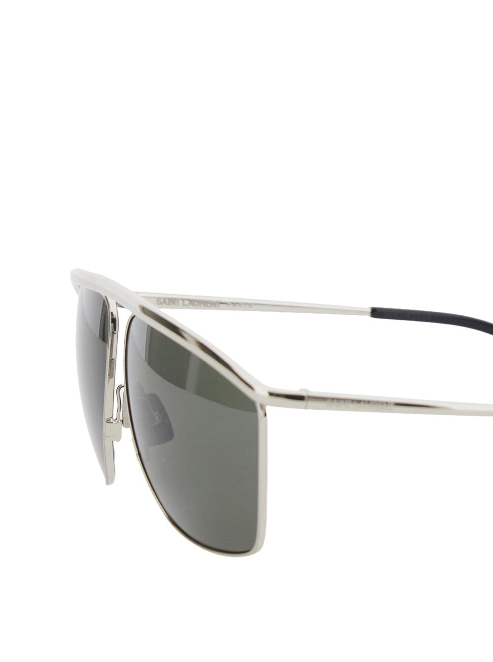 Metallic Saint Laurent SL 820 aviator sunglasses featuring a silver-tone metal frame and a distinct curved top bar, showcased against a clean white background.