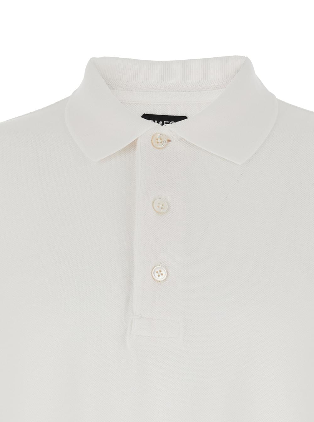 A crisp, close-up shot of a white Tom Ford men's polo shirt featuring a classic collar and front button detailing, set against a clean white background.