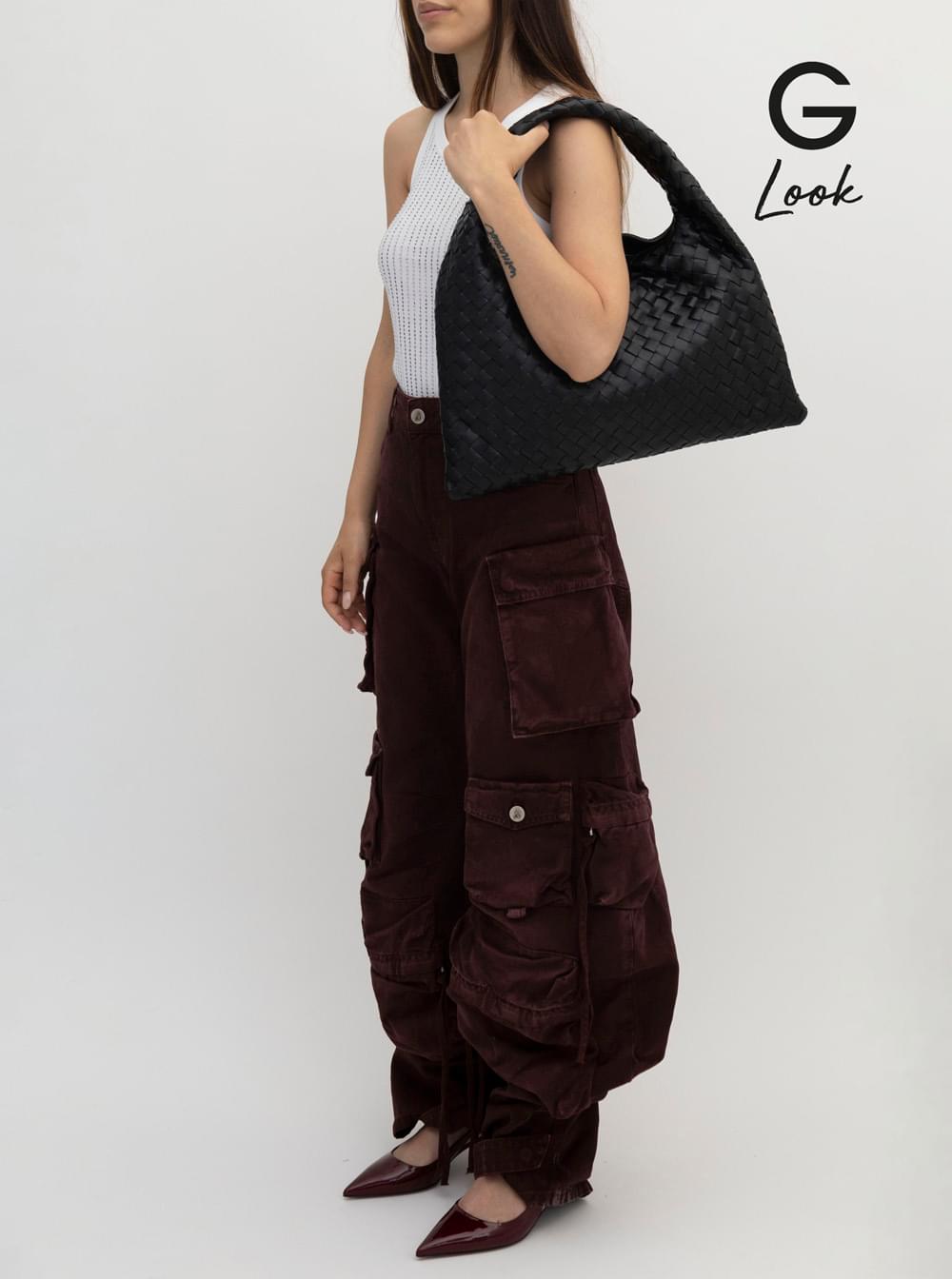 Capture the essence of the Bottega Veneta Hop Piccola bag styled on a model wearing a white ribbed tank top, dark burgundy wide-leg cargo pants, and pointed-toe heels, set against a light gray studio background with a G Look logo.