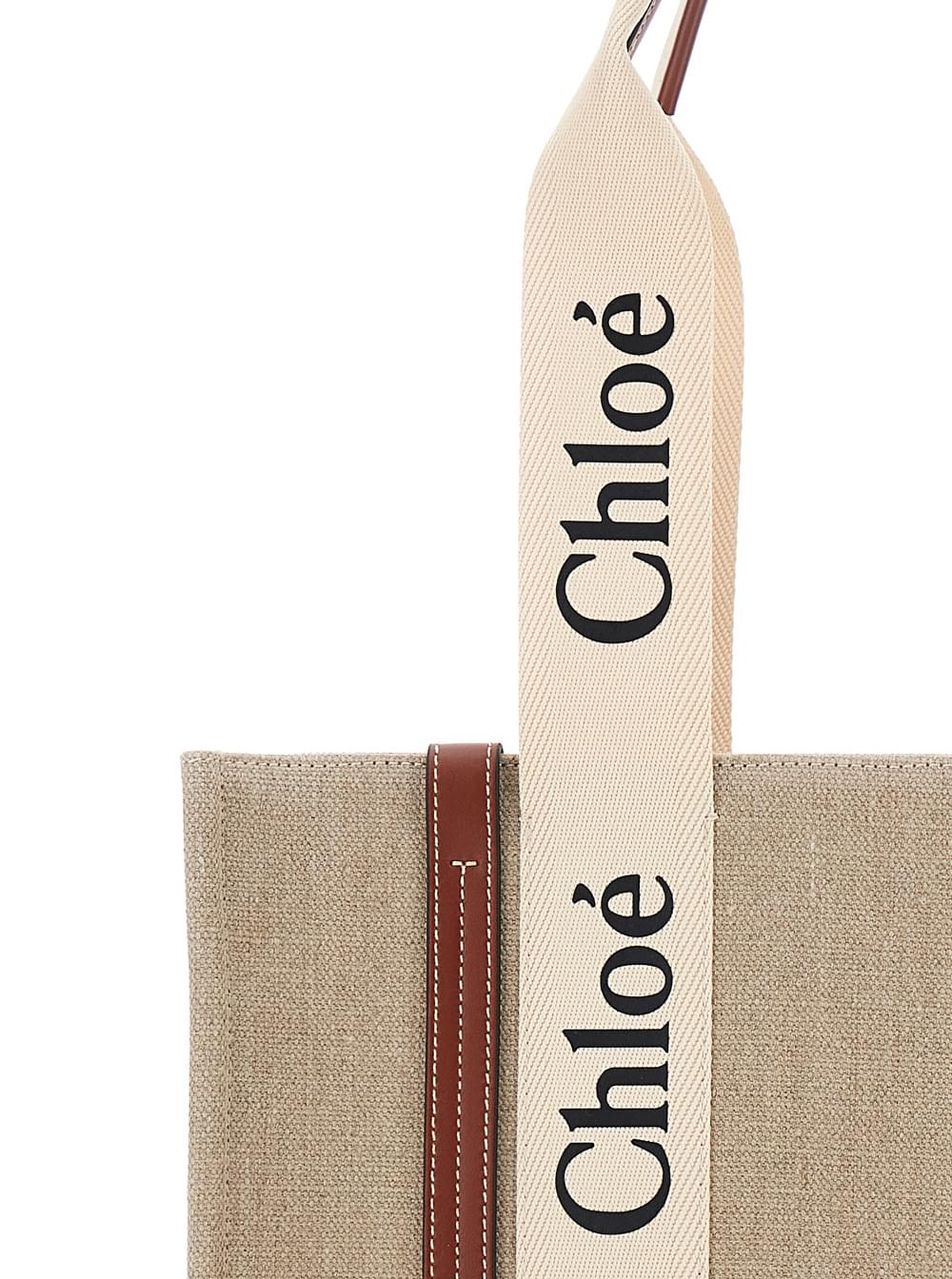 Elevate your style with this iconic Chloé 'Woody' Medium tote in beige linen, featuring the signature logo-printed straps, elegant brown leather trim, and a spacious interior for everyday luxury.