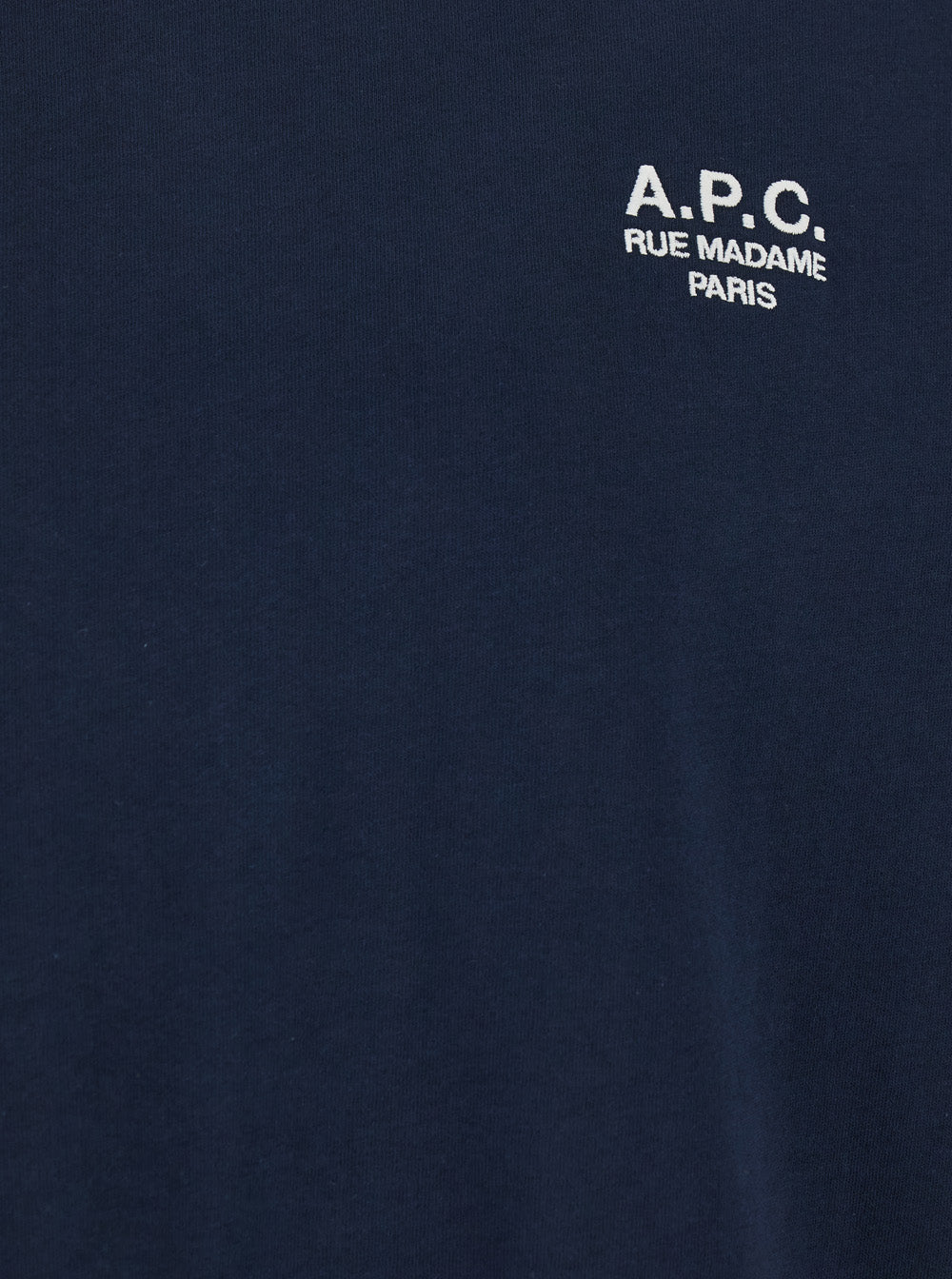Navy blue A.P.C. crew neck t-shirt featuring a white 'A.P.C. Rue Madame Paris' embroidered logo on the chest.