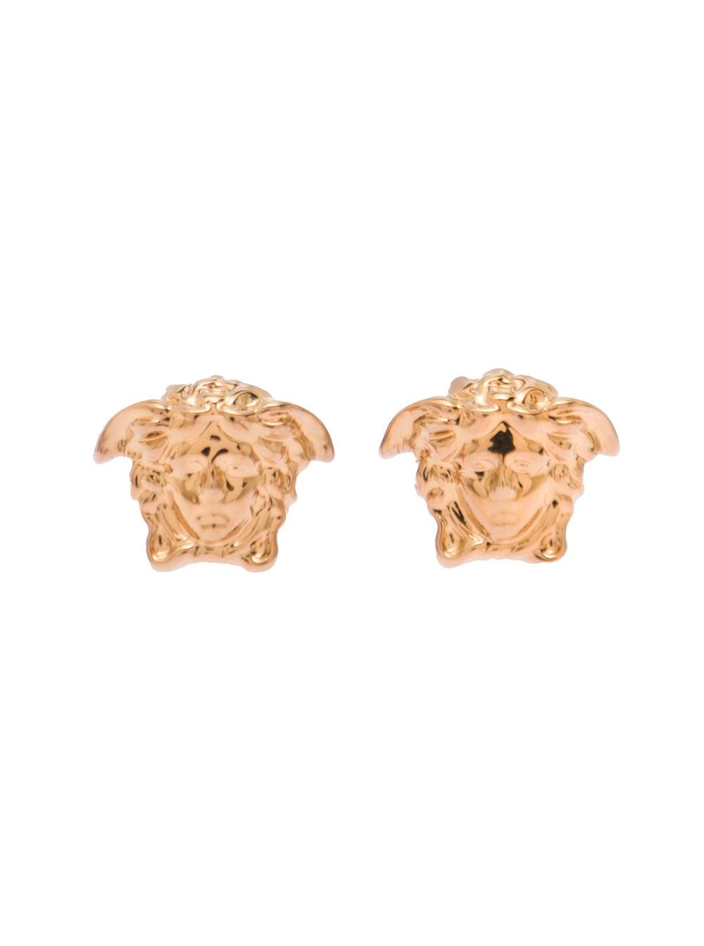 Versace Medusa Head stud earrings in gold-tone brass, featuring an embossed logo detail and butterfly clasp closure, showcased against a clean white background.