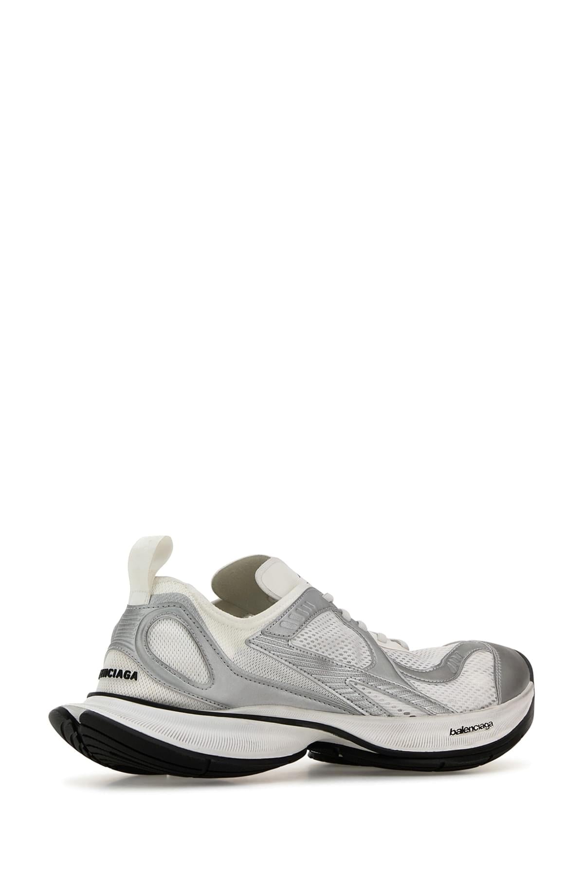 A Balenciaga sneaker in metallic silver and white with black accents, shown from a side profile on a clean white background.