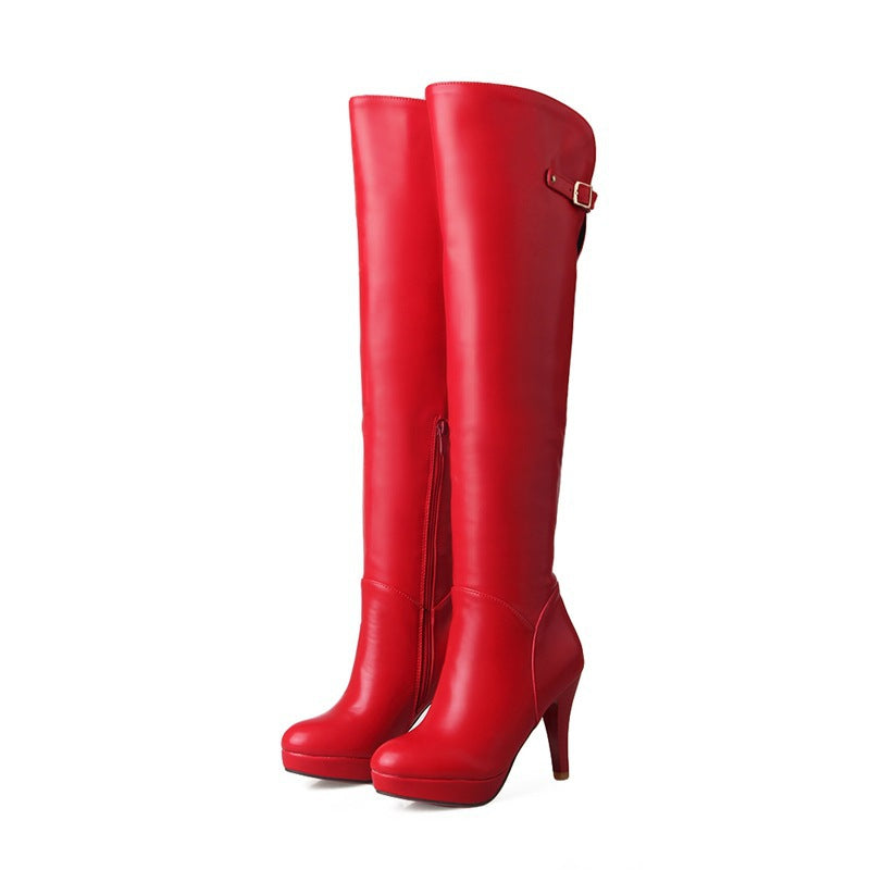 Red knee-high boots on a white background