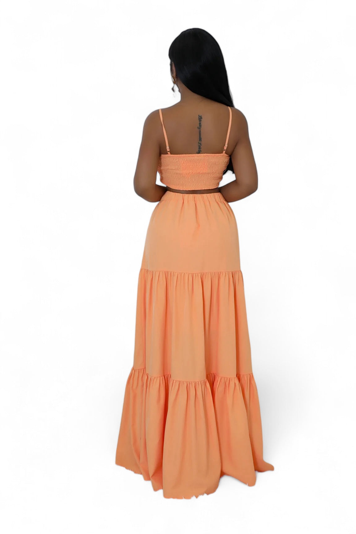 Woman wearing an orange dress with a white background