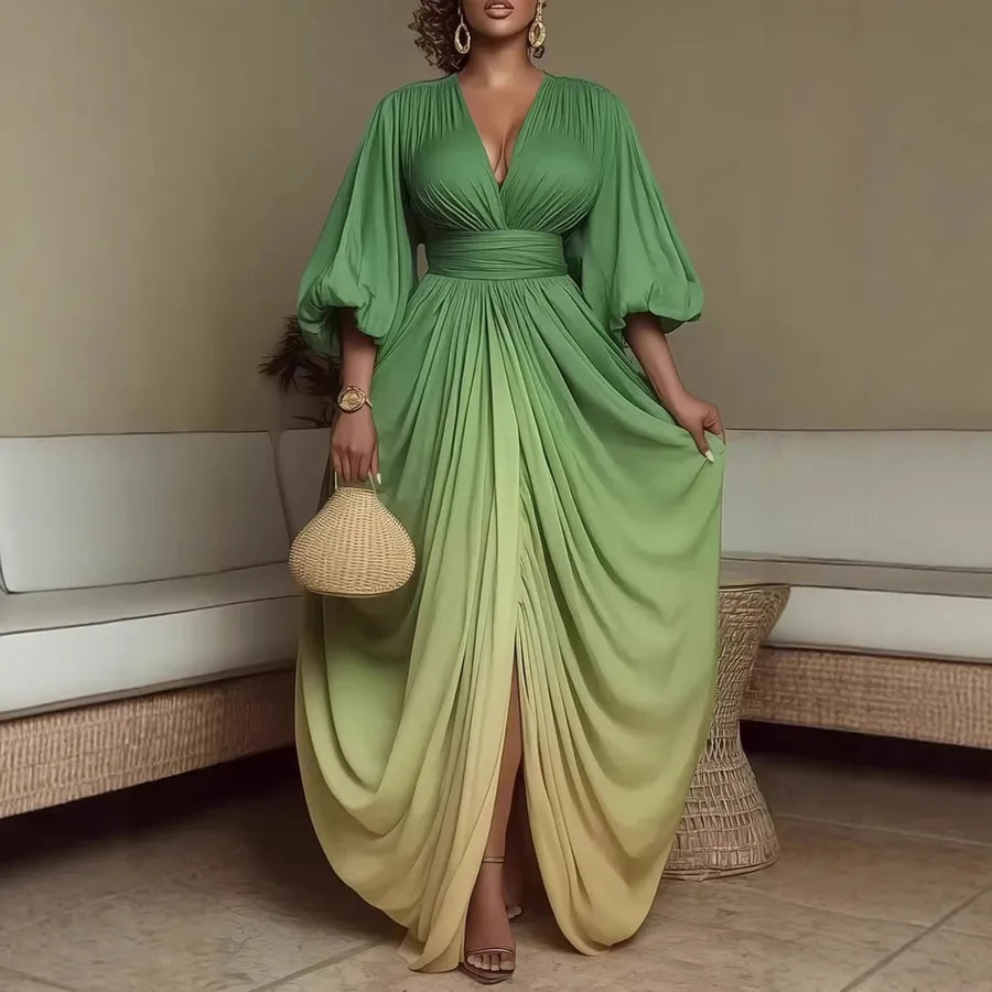 Woman wearing a green flowing dress holding a woven handbag indoors.