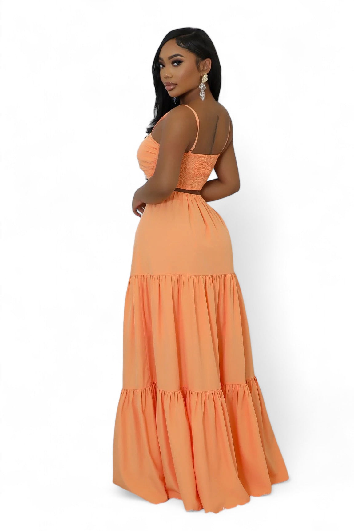 Woman wearing an orange dress against a white background