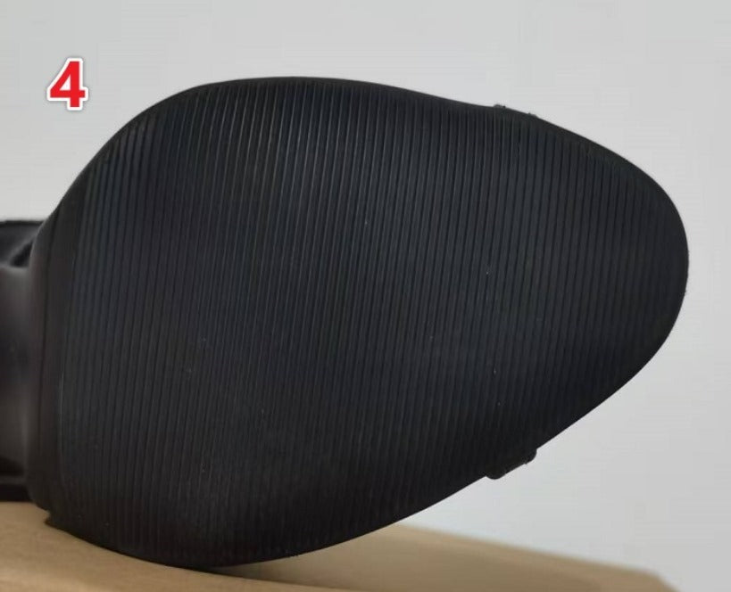 Close-up of a black shoe sole on a light gray background