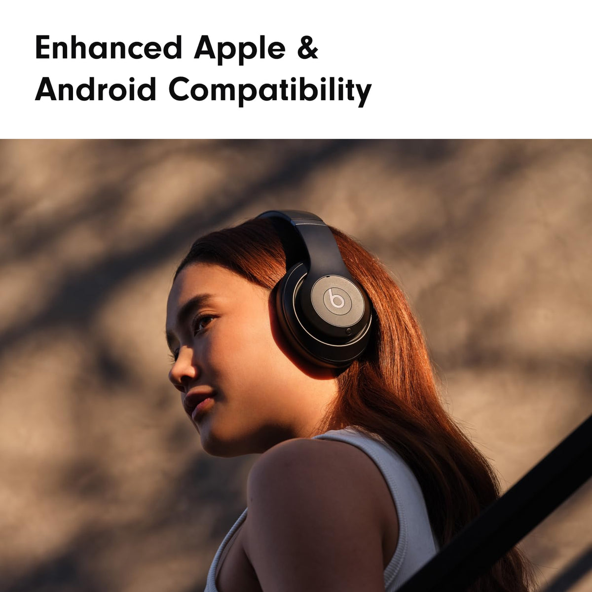 Person wearing headphones with 'Enhanced Apple & Android Compatibility' text