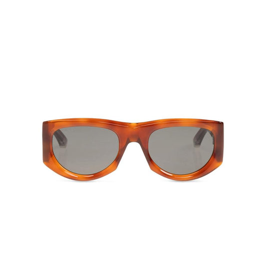 Oversized square sunglasses with a translucent amber-brown acetate frame and dark gray lenses, shown against a plain white background.