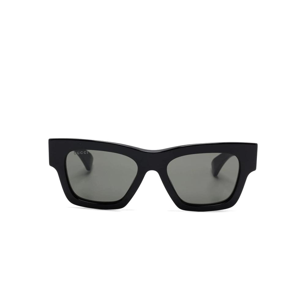 Black Gucci sunglasses with a white background