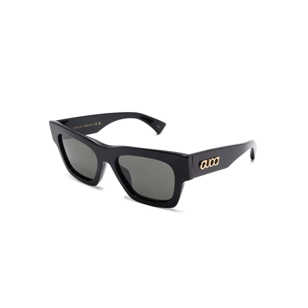 Black Gucci sunglasses with gold logo on a white background