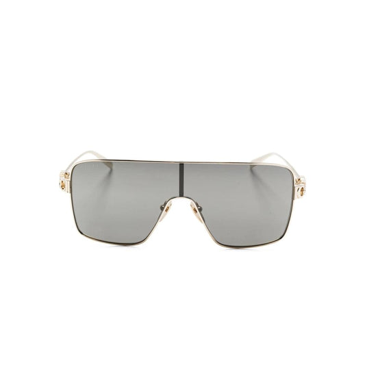 Sunglasses with gold frame and gray lenses on a white background
