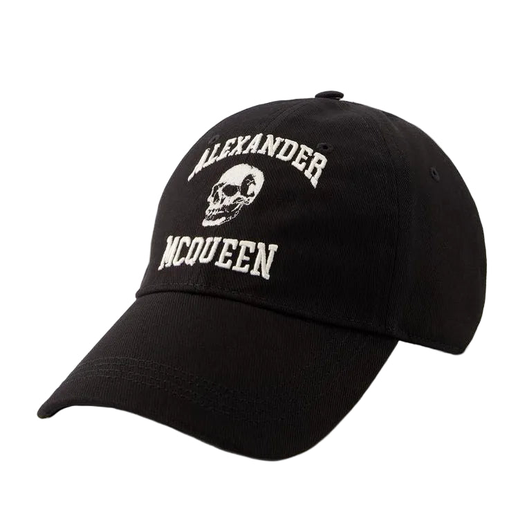 A black baseball cap featuring white embroidered text reading 'ALEXANDER MCQUEEN' and a white skull graphic on the front, set against a light gray background.