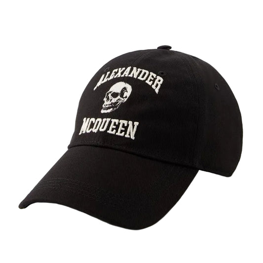 A black baseball cap featuring white embroidered text reading 'ALEXANDER MCQUEEN' and a white skull graphic on the front, set against a light gray background.