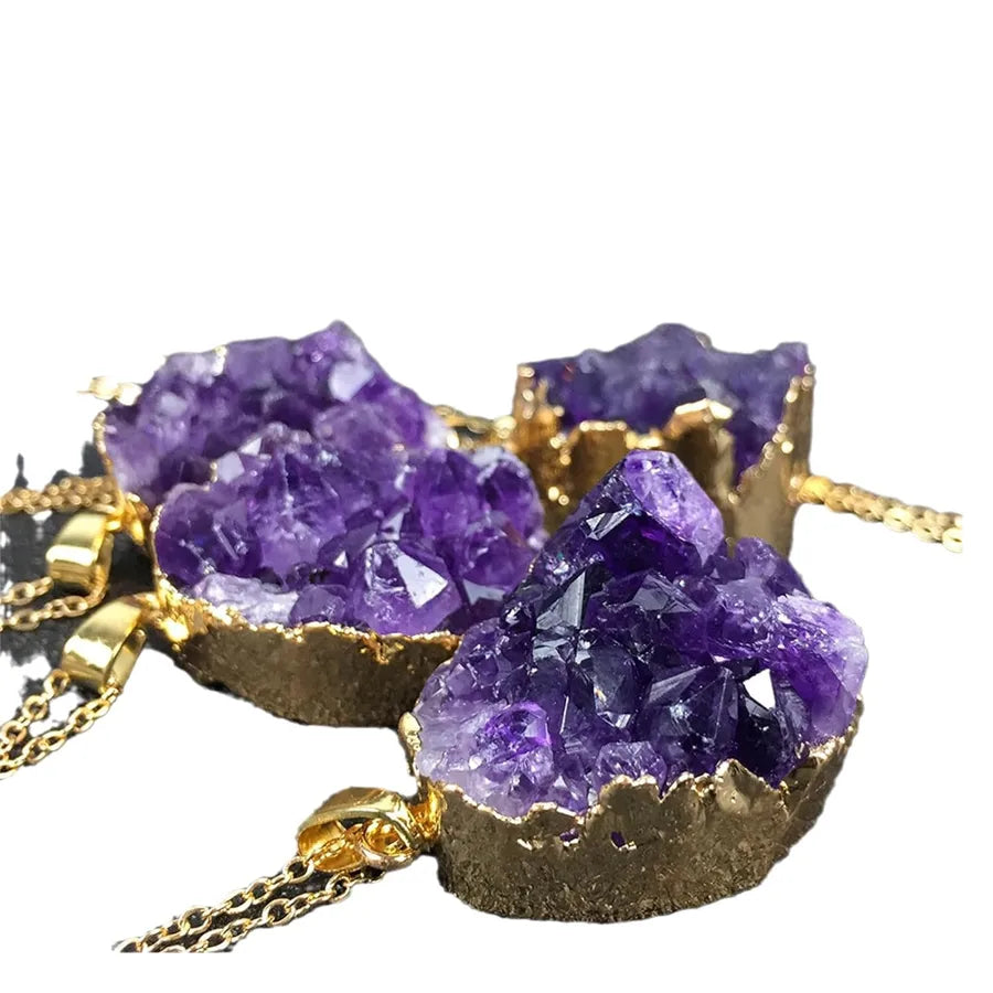 Purple crystal necklace with gold accents on a white background