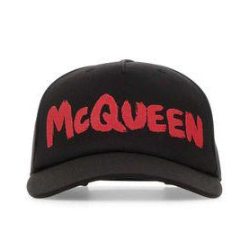 A black baseball cap featuring the word 'McQUEEN' embroidered in a bold red font across the front, set against a plain white background.