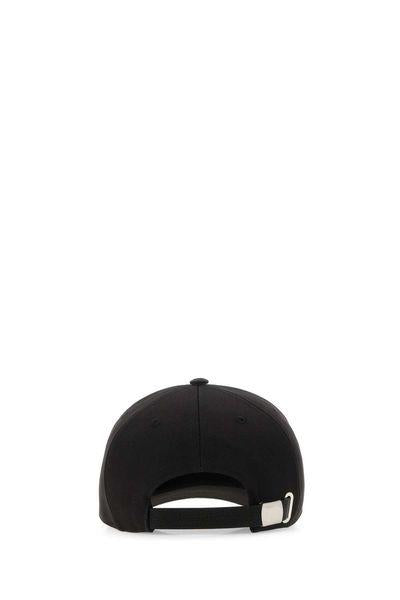 Black baseball cap shown from the back, featuring a black adjustable strap with a silver metal buckle, set against a plain white background.