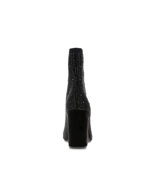 A single black ankle boot with a high block heel, covered in sparkling rhinestones, shown from a rear three-quarter view against a plain white background.