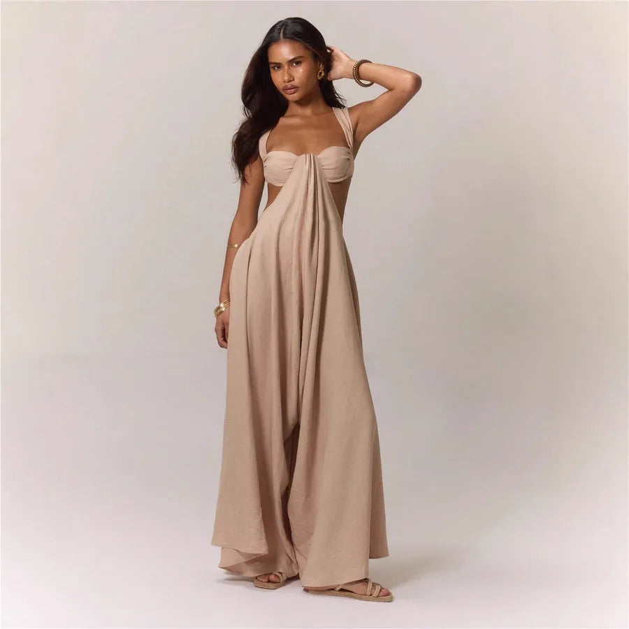 Woman wearing a beige strapless gown against a plain background