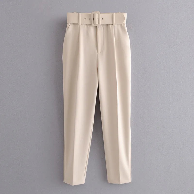 Beige pants with a belt on a gray background