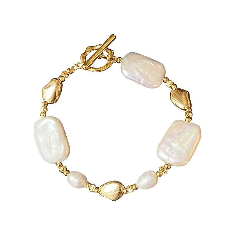 Pearl bracelet with gold accents on a white background