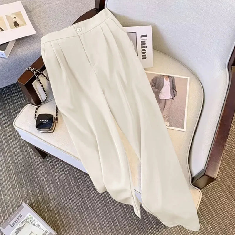 Beige pants on a chair with a magazine and handbag in the background