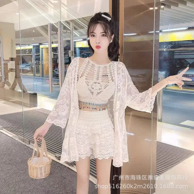 Woman in a white lace outfit holding a basket in an indoor setting
