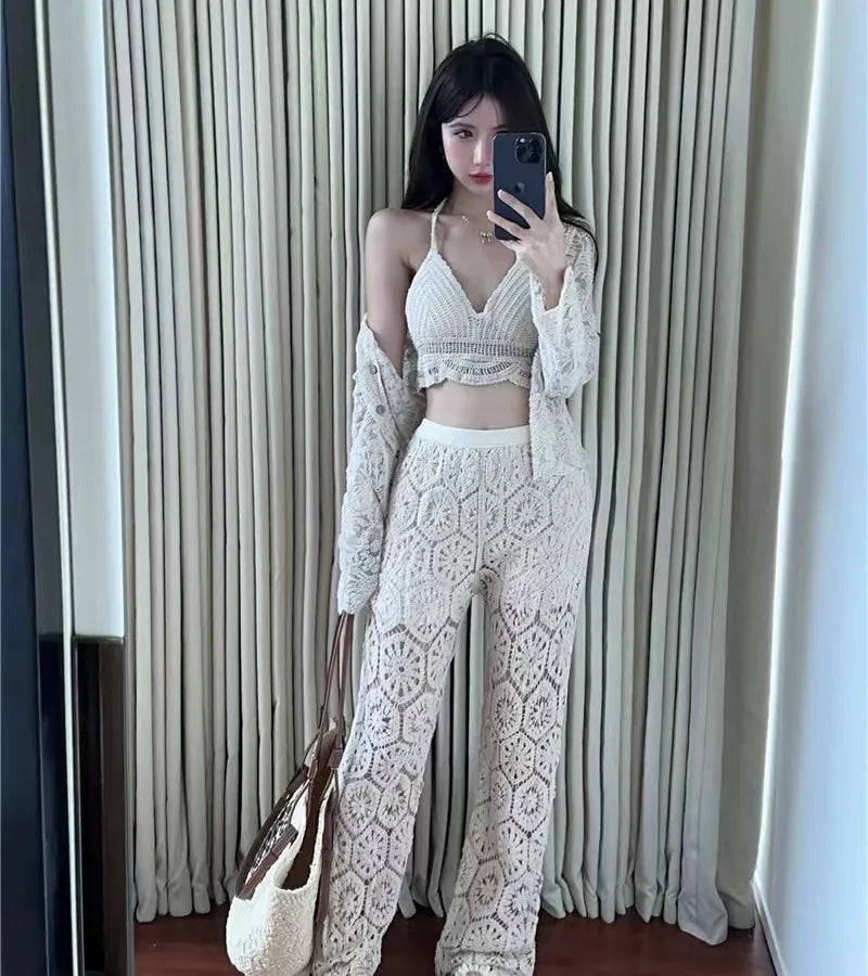 Woman taking a mirror selfie wearing a white lace outfit with a matching handbag.