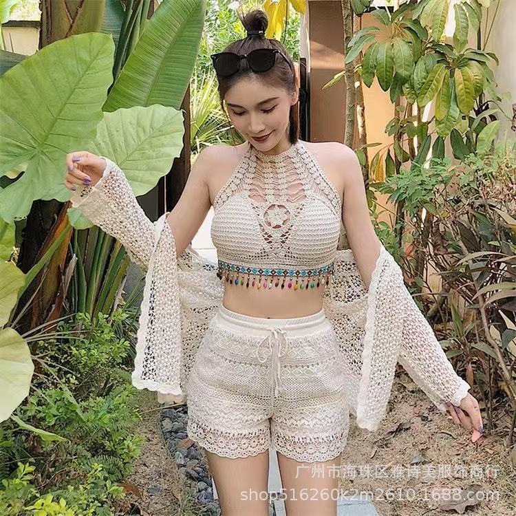 Woman in a white lace outfit standing in a garden