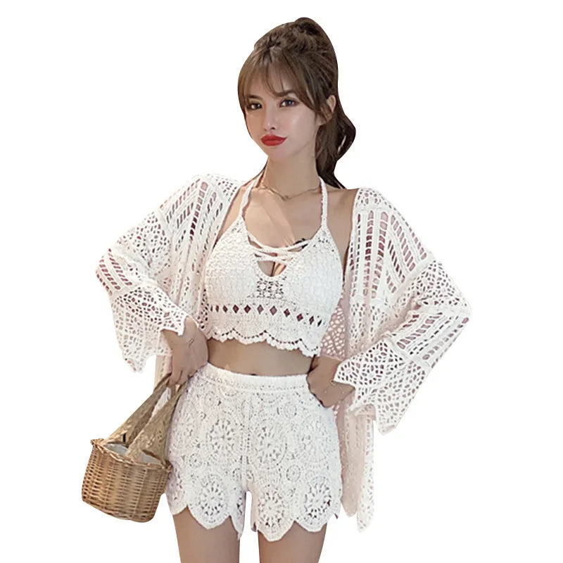 Woman wearing a white crochet outfit with a beige bag on a white background