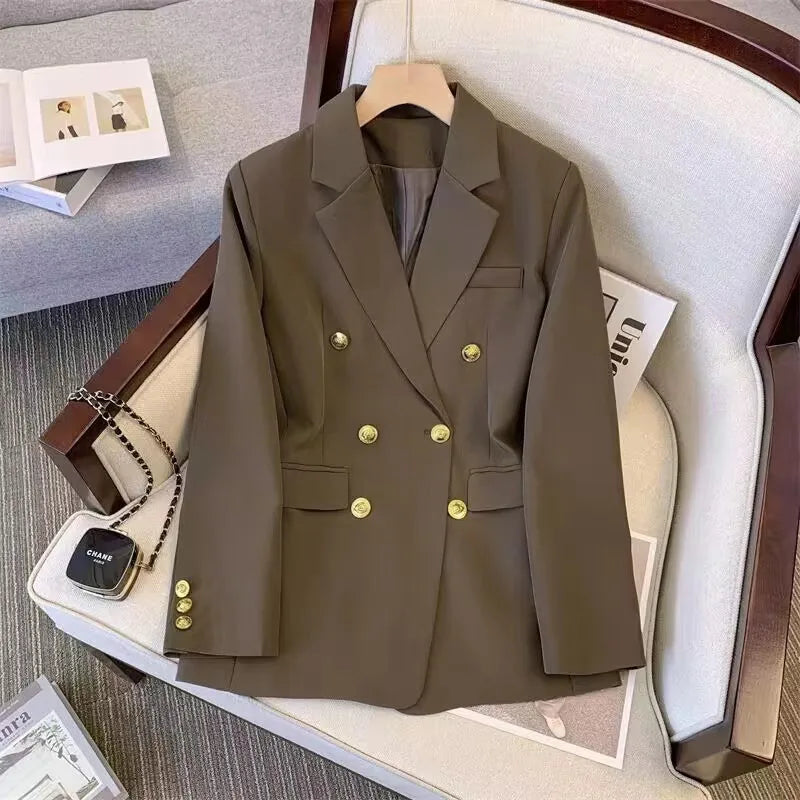 Brown blazer with gold buttons on a hanger against a neutral background