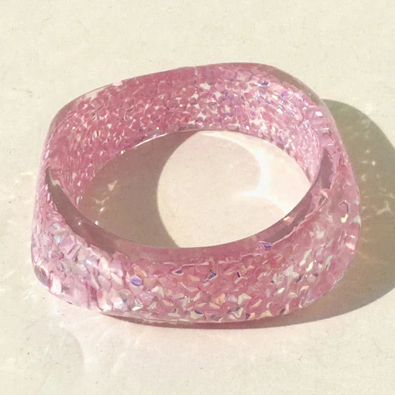 Pink glittery ring on a light background