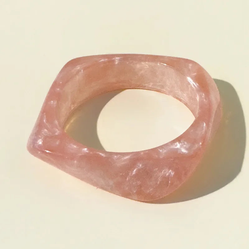 Pink stone bracelet on a light beige background