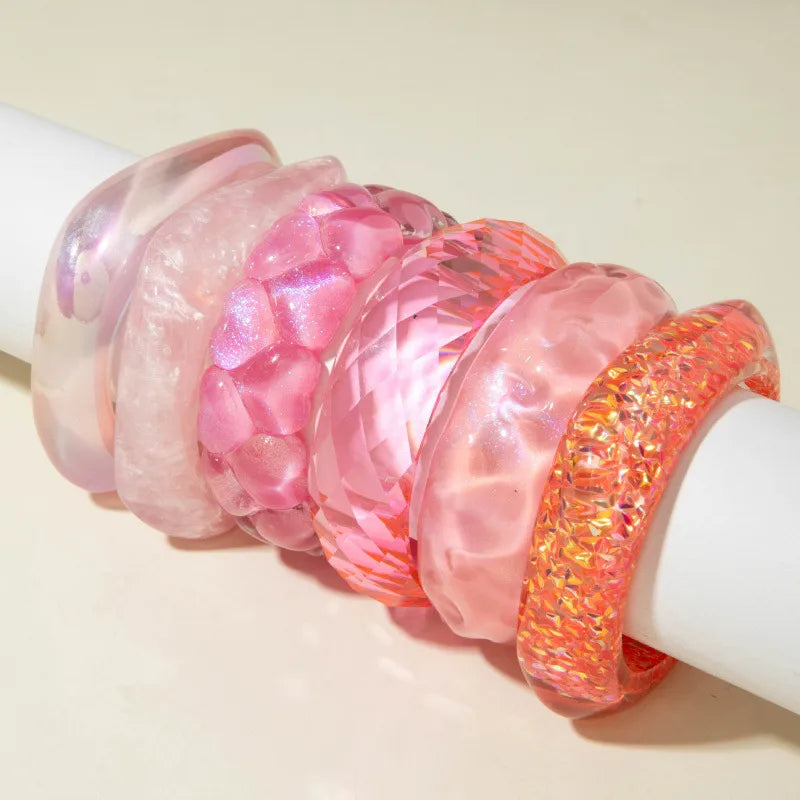 Set of pink and orange bangles on a white background